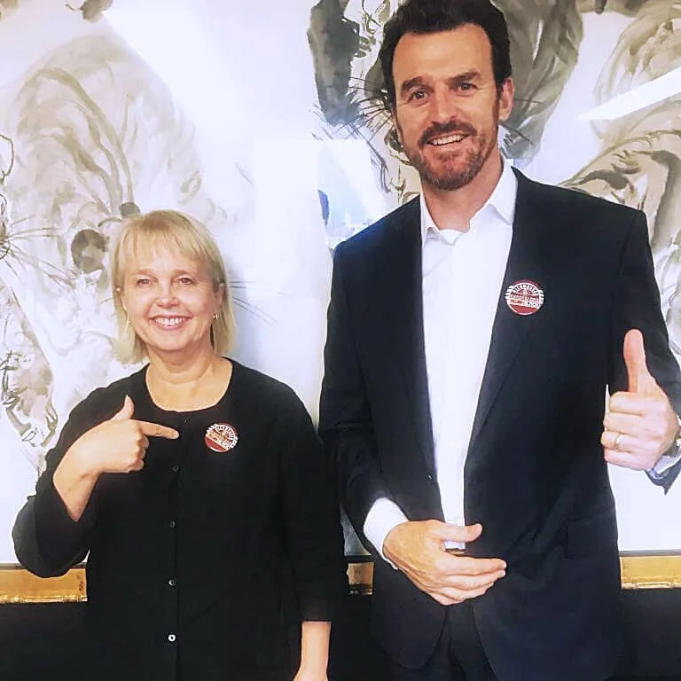 Brendon Gale and Peggy O'Neal waring Richmond badges made by League Tees